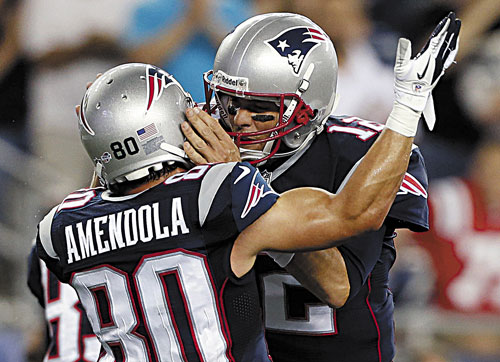 NICE JOB: New England Patriots wide receiver Danny Amendola (80) celebrates his touchdown catch on a pass from quarterback Tom Brady, right, against the Tampa Bay Buccaneers earlier this preseason in Foxborough, Mass. Of his top five receivers, three are rookies, Amendola signed as a free agent and Julian Edelman has been sidelined for part of training camp.