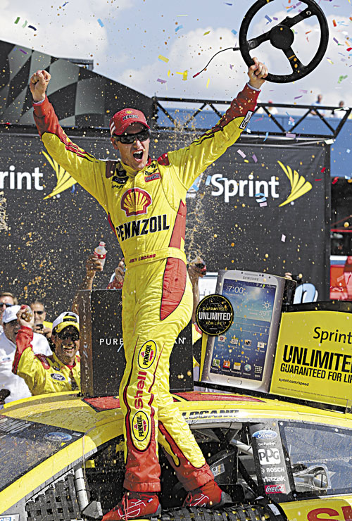 YES! Joey Logano celebrates after winning the Pure Michigan 400 race Sunday at Michigan International Speedway in Brooklyn, Mich.