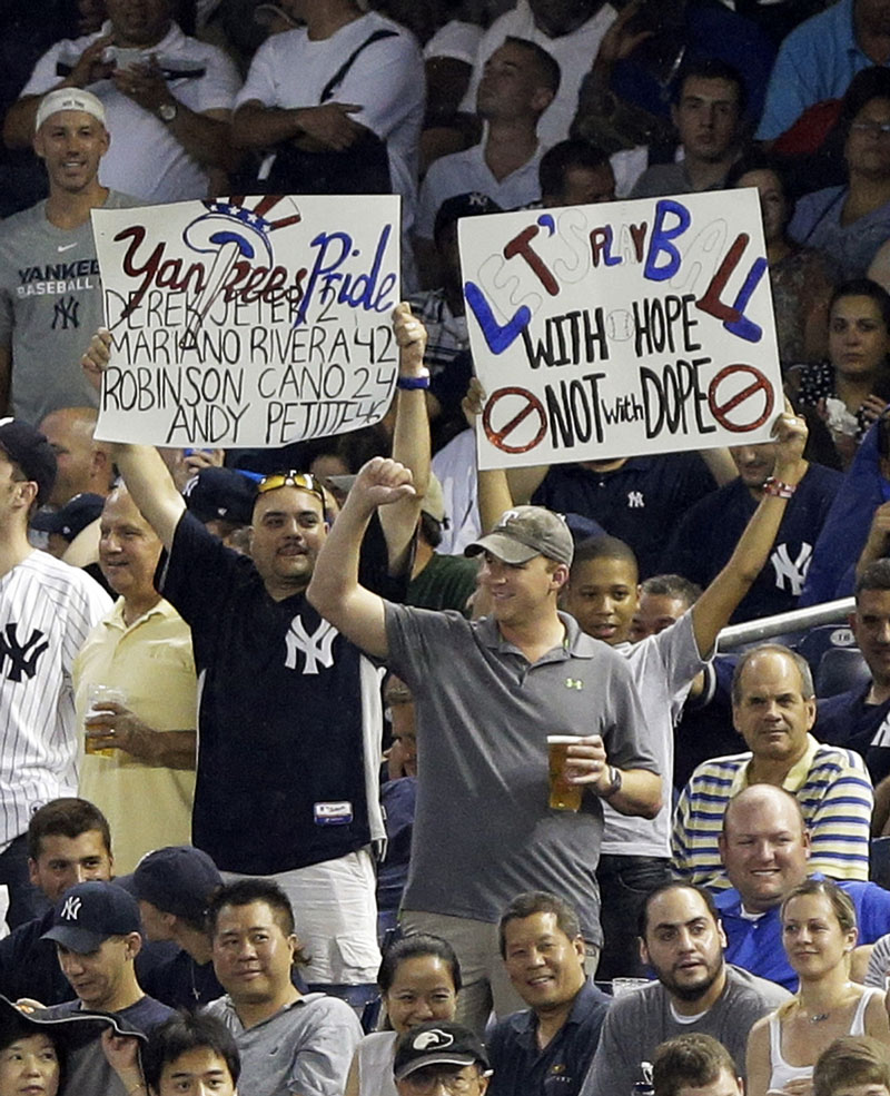 SHOWING THEIR FEELINGS: Fans hold up signs during Alex Rodriguez’s first at-bat in the first inning of the Yankees’ game against the Detroit Tigers on Friday in New York.