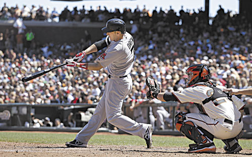 SMASHED: Boston’s Stephen Drew hits a three-run home run off San Francisco Giants pitcher Michael Kickham during the seventh inning Wednesday in San Francisco. Giants catcher Buster Posey looks on.