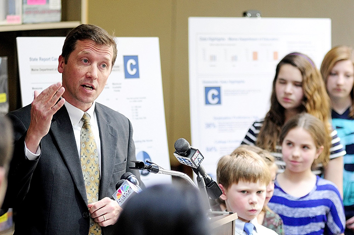In this May 2013 file photo, education commissioner Stephen Bowen, surrounded by students, unveils the state's new A-F grading system at the Maine State Library.