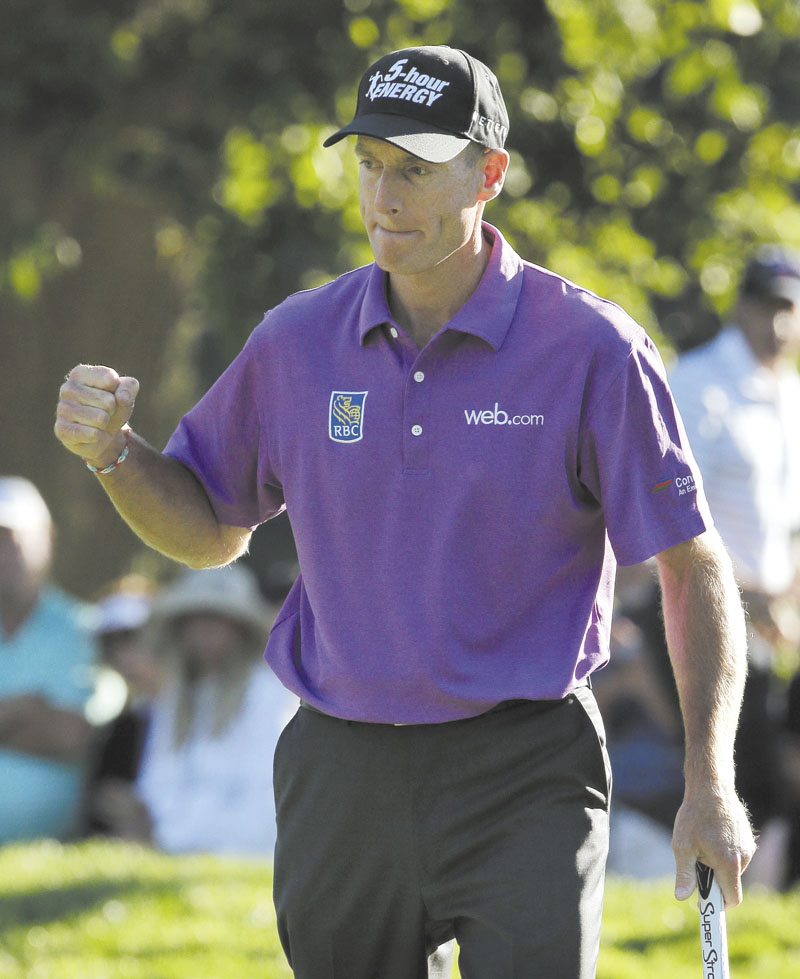 SOLID WORK: Jim Furyk celebrates after a birdie on the 17th hole during the third round of the PGA Championship on Saturday at Oak Hill Country Club, Saturday in Pittsford, N.Y. Furyk shot 68 in the third round and is 9-under for the tournament. He has a one-shot lead over Jason Dufner heading into today’s final round
