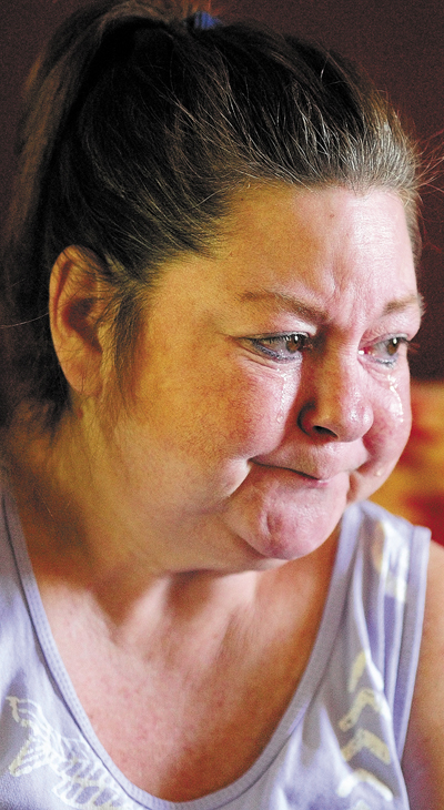 Pamela Tardiff cries while telling the story of her frustrations with the new ride scheduling system on Friday in Augusta. Tardiff uses an powered wheelchair and has had trouble getting rides to doctors appointments.