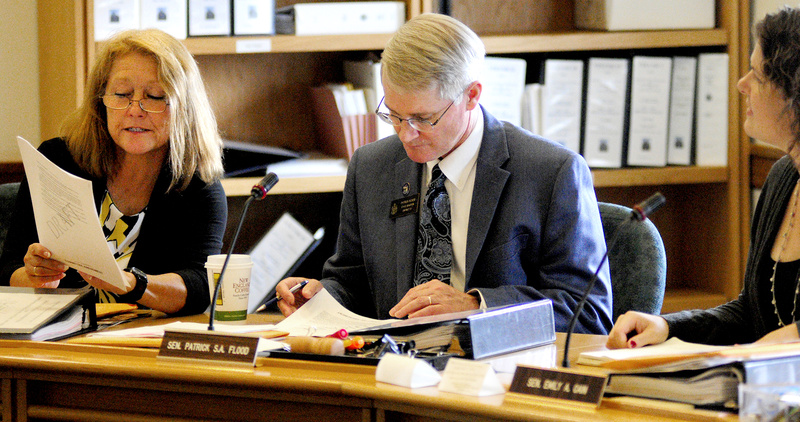 Rep. Kathleen Chase, R-Wells, Sen. Patrick Flood, R-Winthrop, and Sen. Emily Cain, D-Orono, confer over a draft version of L.D. 1515 before a work session of the Appropriations and Financial Affairs committee Thursday at the State House in Augusta.