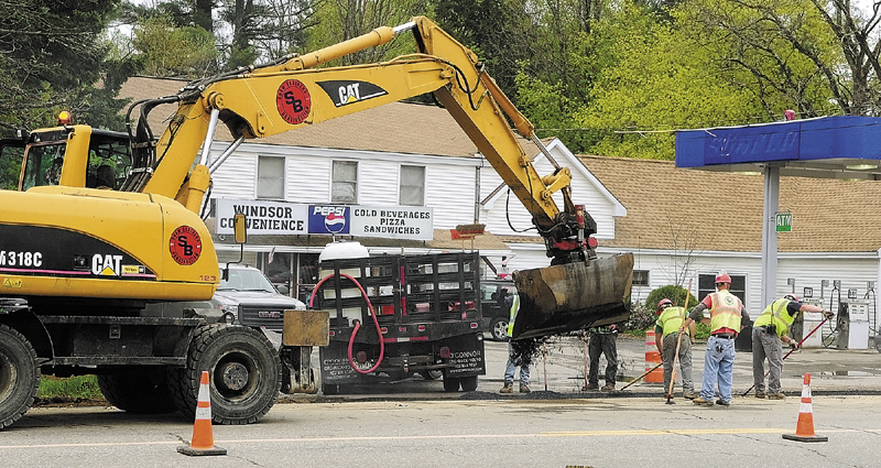 Paving crews work in front of Windsor Convenience in May, covering over a trench where natural gas pipeline was laid along Route 17 in Windsor. Both Summit Natural Gas of Maine and Maine Natural Gas plan to submit bids to serve state-owned properties across central Maine, the companies said today.