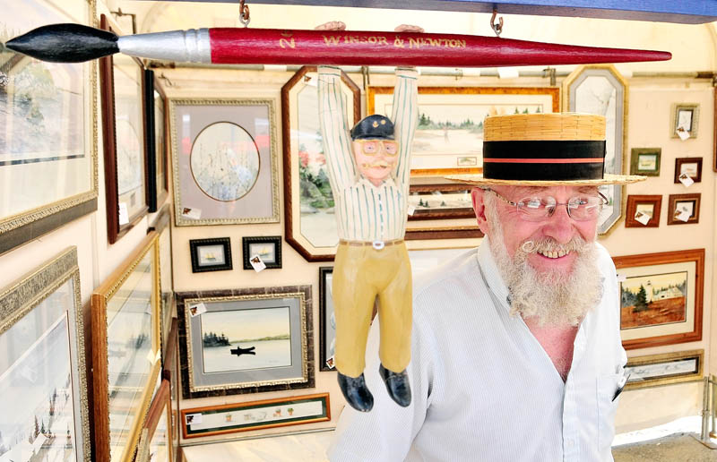 Artist Marvin Jacobs stands in his booth at the 26th annual Winthrop Sidewalk Art Show today in downtown Winthrop.