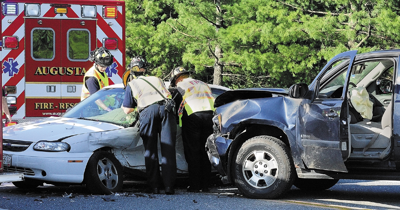 Augusta firefighters work to remove the driver of a passenger car that was struck broad side by an SUV around 5 p.m. on Wednesday in the intersection of Xavier Loop and Civic Center Drive near the entrance to Marketplace At Augusta.