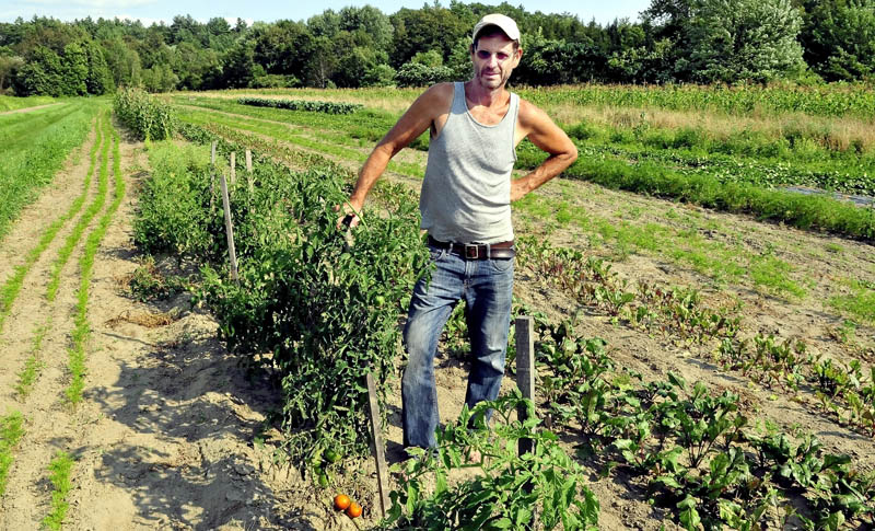 Farmer Jay Robinson stands in one of his vegetable fields in Starks. Robinson is behind an effort to create a labor pool to employ local workers at his farm.
