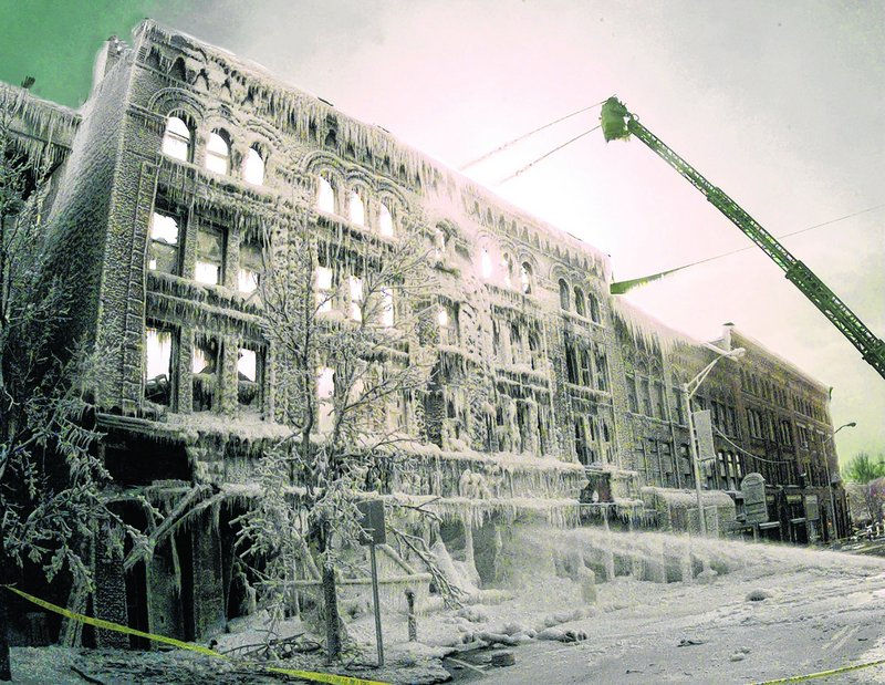 In this Jan. 28, 2000 file photo, firefighters keep dousing the Daniels building in St. Johnsbury, Vt. U.S. Sen. Patrick Leahy is proposing the creation of a tax credit for building owners who install fire suppression equipment. Leahy is making the announcement Friday, Aug. 9, 2013, in downtown St. Johnsbury, which has suffered three major downtown fires since 2000 that killed three people and caused millions of dollars in damages. (AP Photo/Toby Talbot, File)