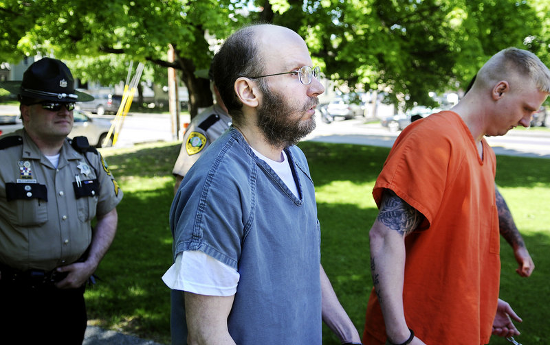 In this May 2013 file photo, Christopher Knight, center, is escorted to Kennebec County Superior Court. Police said that Knight, known as the North Pond Hermit, lived in the woods of Rome, Maine for 27 years, allegedly burglarizing nearby camps for food and supplies hundreds of times in order to survive.
