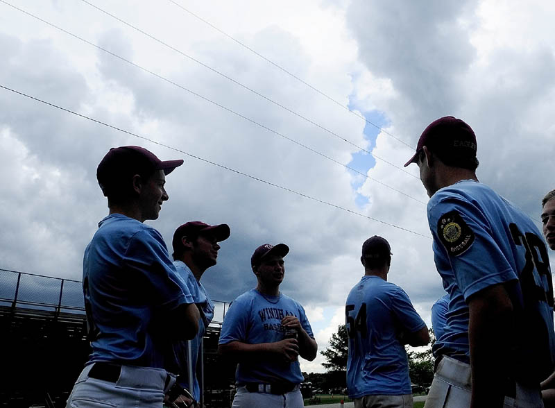NO FUN: Players on the Windham American Legion baseball team wait in the parking lot watching storm clouds roll in on Sunday at Morton Field in Augusta. They had beaten Bangor 5-4 earlier in the day. But then the state championship game against Westbrook was postponed until 2 p.m. today because of the weather.