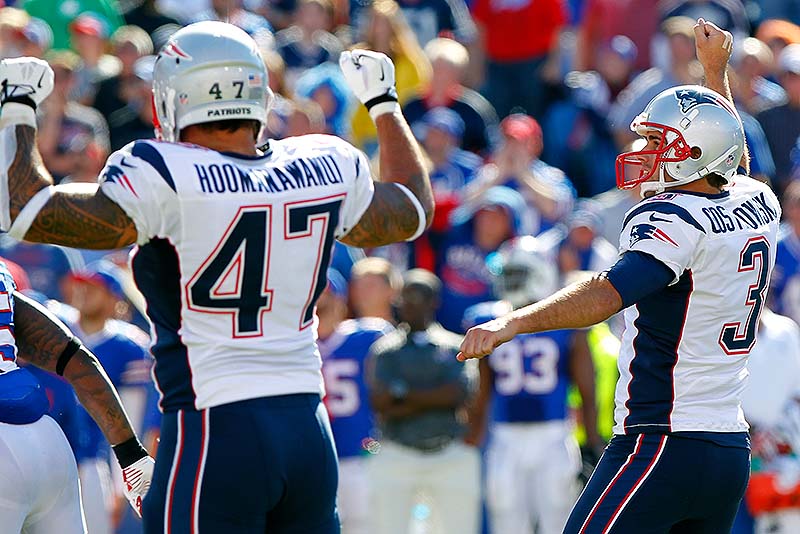 Stephen Gostkowski, right, celebrates with teammate Michael Hoomanawanui after kicking the winning field goal with 5 seconds left in the game Sunday at Orchard Park, N.Y. The Pats won, 23-21.