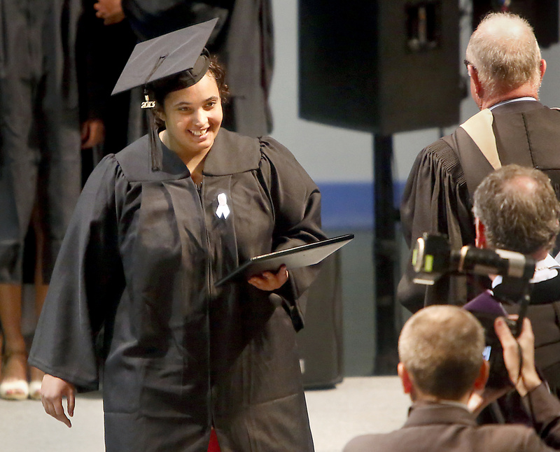 Felicity Hills, who earned her degree in mathematics and physics, walks across the stage with her diploma during the Bowdoin College commencement in May.