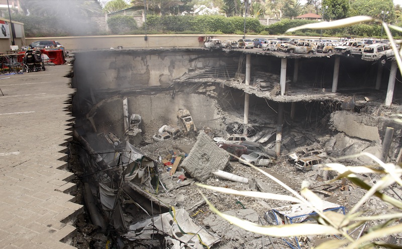 This photo released by the Kenya Presidency shows the collapsed upper car park of the Westgate Mall in Nairobi, Kenya Thursday, Sept. 26, 2013. Working near bodies crushed by rubble in a bullet-scarred, scorched mall, FBI agents continued fingerprint, DNA and ballistic analysis to help determine the identities and nationalities of victims and al-Shabab gunmen who attacked the shopping center, killing more than 60 people. (AP Photo/Kenya Presidency)