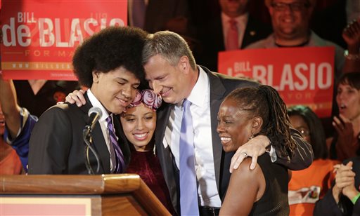 New York City Democratic Mayoral hopeful Bill De Blasio embraces his son Dante, left, daughter Chiara, second from left, and wife Chirlane, right, after addressing supporters at his election headquarters after polls closed in the city's primary election Wednesday, in New York.