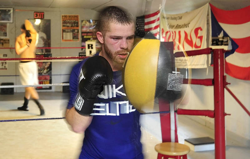 GETTING READY: Brandon Berry works the strike bag during a training session recently at Wyman’s Boxing Club in Stockton Springs. Berry takes on Jesus Cintron in his third professional bout Thursday night in Manchester, N.H.