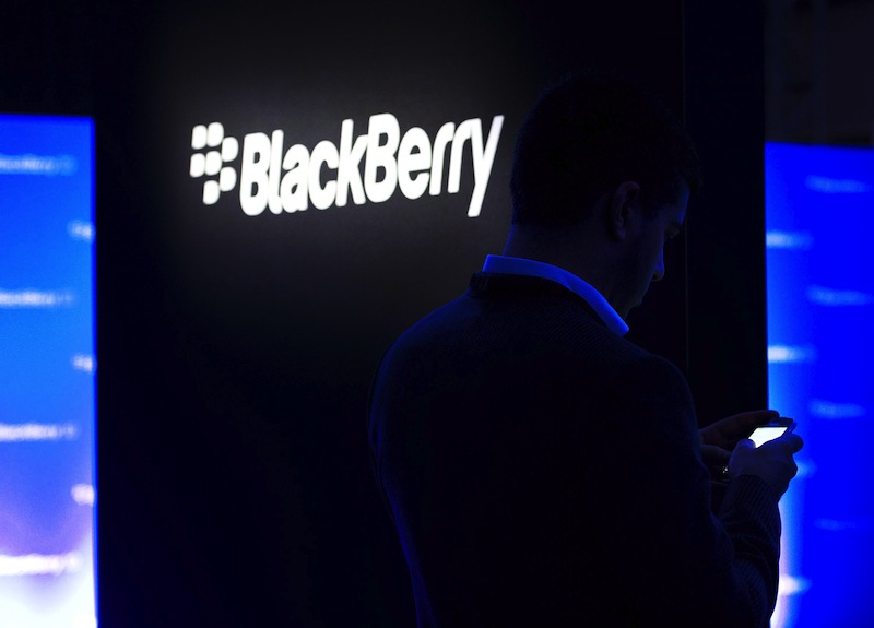 In this Wednesday, Jan. 30, 2013, file photo, a man uses his Blackberry as people wait for the Blackberry BB10 launch in Toronto. Fairfax Financial Holdings has offered to buy BlackBerry in a deal that values the Canadian smartphone company at about US$4.7 billion, on Monday, Sept. 23, 2013. (AP Photo/The Canadian Press, Nathan Denette, File) economic recovery;accession;bank;bull;business;Canada;Canadian;economics;economy;employment;finance;financial;growth;improvement;inflation;issue;issues;market;rebuild;rebuilding;social;society;spend;spending;success;upturn;economy general;exchange;invest;investing;investment;manufacturing;assembly;build;building;commercial;company;factories;factory;industrial;industry;line;plant;retail;commerce;economic;employ;job;labor;merchant;product;production;products;shop;shopping;supply;trade;work;communication;automated;automation;communicate;communicating;connect;connected;connection;contact;digital;tech;transfer;transferring;transmission;technology;electronics;data;object;objects