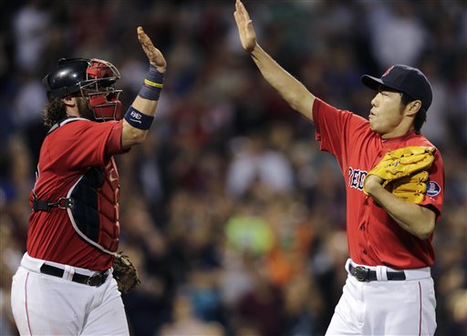 Boston Red Sox relief pitcher Koji Uehara, right, is congratulated by catcher Jarrod Saltalamacchia after striking out Toronto Blue Jays' J.P. Arencibia to end the top of the eighth inning of a baseball game at Fenway Park, Friday in Boston.
