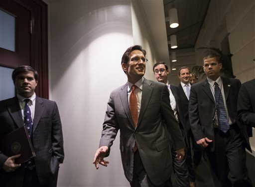 House Majority Leader Eric Cantor, R-Va., arrives for a closed-door meeting with fellow Republicans as the House of Representatives worked into the night to pass a bill to fund the government, at the Capitol in Washington on Saturday.