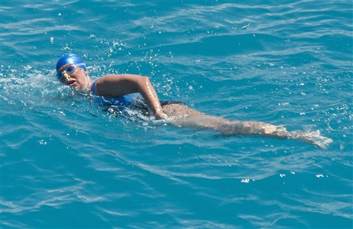 In this Monday, Sept. 2, 2013, photo Diana Nyad, positioned about two miles off Key West, Fla., swims toward the completion of her 111-mile trek from Cuba to the Florida Keys.
