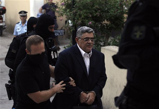 Golden Dawn party leader Nikos Michaloliakos, center, is escorted by antiterror police to court in Athens, Greece, today. Police arrested Michaloliakos and other top members of Golden Dawn in an escalation of a government crackdown, following a fatal stabbing allegedly committed by a supporter. It is the first time since 1974 that sitting members of Parliament have been arrested.