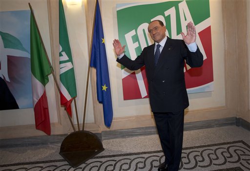 Former Italian Premier Silvio Berlusconi pauses for photographers Thursday at the inauguration of his "Forza Italia" (Go Italy) party's new headquarters in Rome. Government ministers in Berlusconi's party announced Saturday their intentions to resign, a move that raises tension in the uneasy coalition government and increases the possibility of early elections.