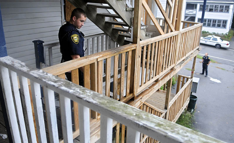 Augusta Police Officers Niko Hample, left, and Ben Murtiff search an apartment building Thursday on Jefferson Street that was closed by the City of Augusta. The Augusta City Council is considering a proposed rental housing standard for General Assistance recipients. The building was closed after several code violations were discovered, according to police.