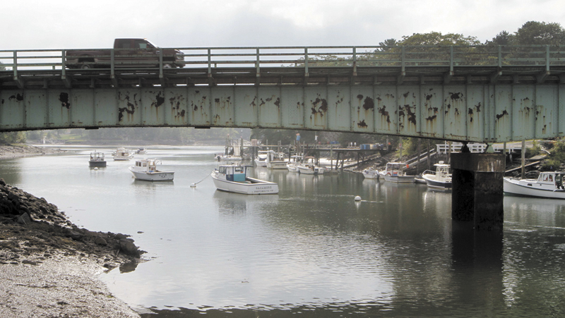 A pickup truck drives on a bridge over Sagamore Creek in Portsmouth, N.H. on Sept. 4. According to federal records from 2012, the bridge is one of several in New Hampshire that are considered both "structurally deficient" and "fracture critical."