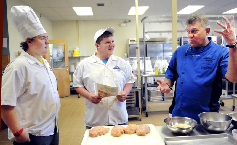 Chef Michael Barna, right, teaches Capital Area Technical Center culinary students Josh Pare, center, Travis Selwood how to bread a chicken breast Thursday at the Augusta school. Barna will appear at the The Taste of Home Cooking School in Augusta on Saturday.