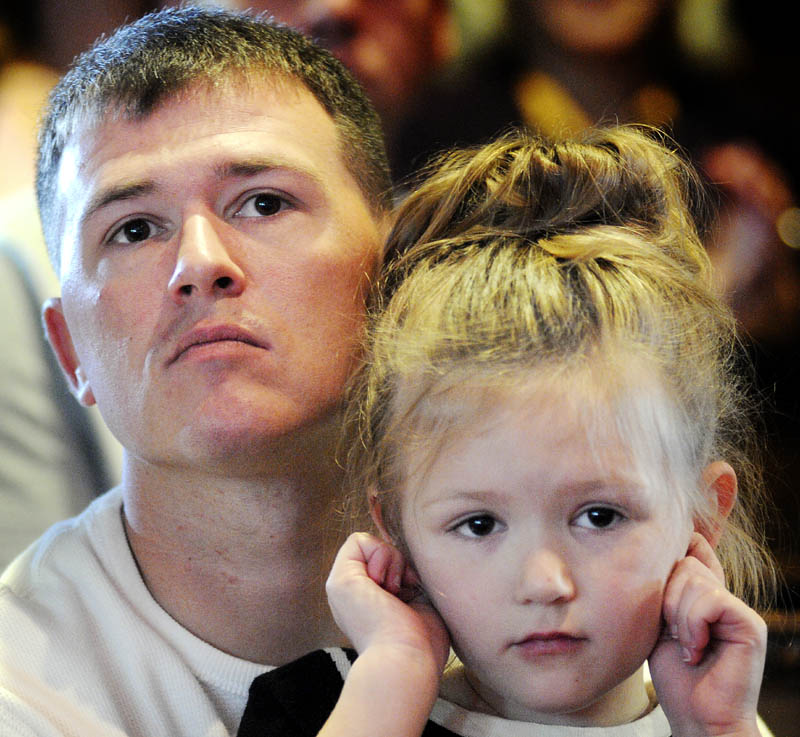 Travis Bentley holds his daughter, Reese, Tuesday during the first graduation ceremony for veterans at the Co-Occuring Disorders Court and Veterans Court at Kennebec County Superior Court in Augusta. Bentley, a Marine combat veteran of Iraq, graduated with Daniel Andrews, an Army combat veteran of Iraq.
