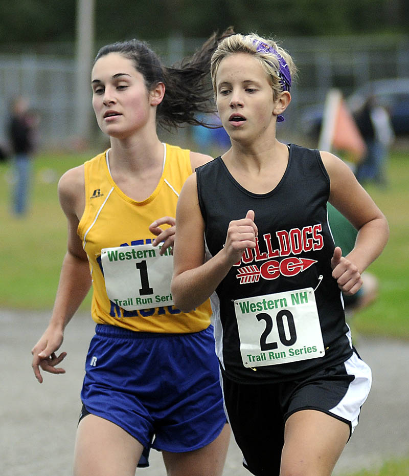 Hall-Dale High School’s Emma Wilson, right, runs next to Boothbay High School’s Sophie Thayer during a cross country meet Wednesday at the University of Maine in Augusta. Thayer won the race and Wilson finished second.