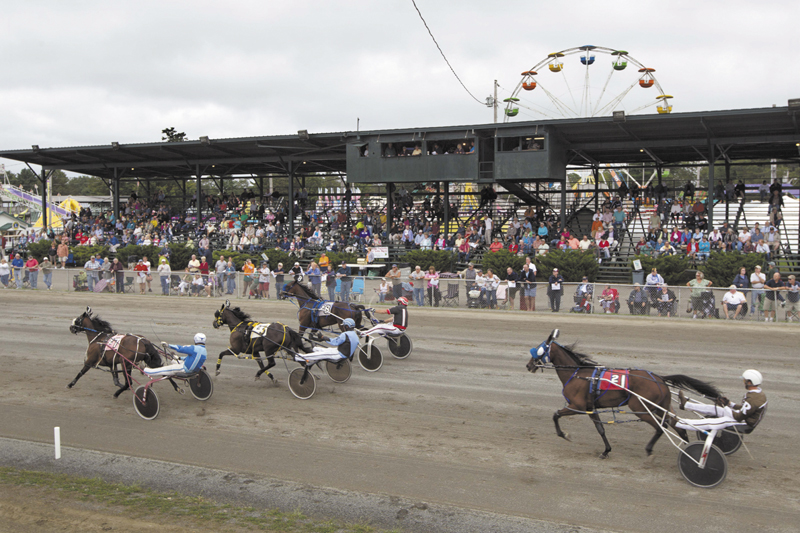 Harness race horses cross the finish line at the Windsor Fair in Windsor. The state's casinos were supposed to help harness-racing tracks by funneling some of the proceeds to them, allowing them higher payoffs to keep horsemen from leaving the state. Instead, race tracks are struggling more than ever because wagering on horse races has fallen off as patrons migrate to casinos.