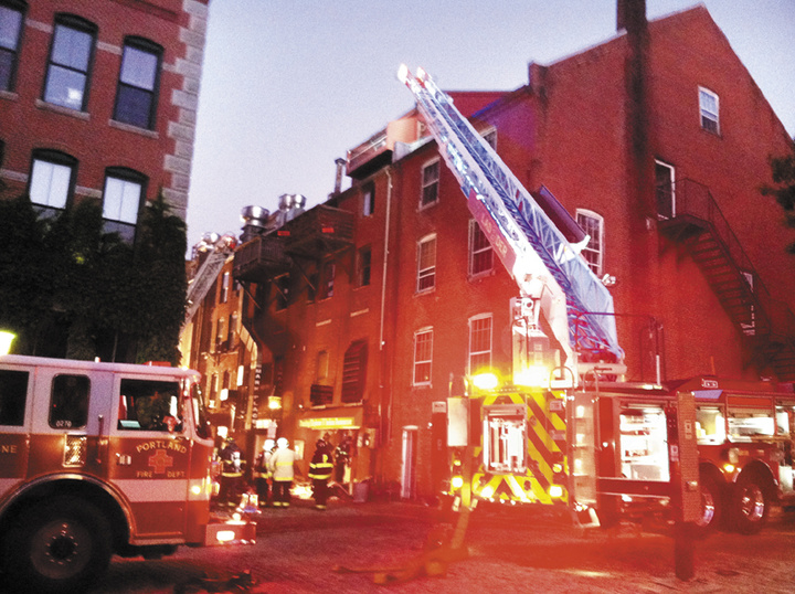 Firefighters work to put out a fire in the 400 block of Fore Street in Portland.