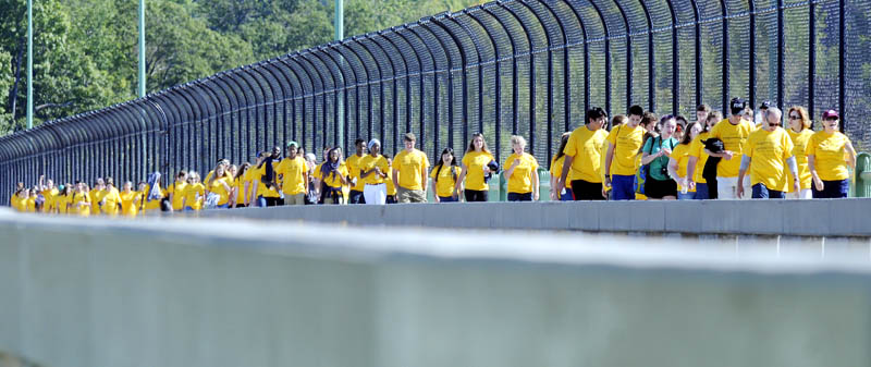 Volunteers walk across Memorial Bridge Sunday in Augusta during a fundraiser for Seeds of Peace, an international non-profit that brings together young people from around the world in the name of peace.