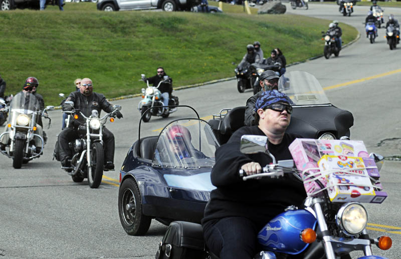 Bikers drive through Augusta today during the 32nd annual United Bikers of Maine Toy Run. Hundreds of motorcycles cruised in a caravan through Central Maine en route to the Windsor Fairgrounds to donate toys they collected.
