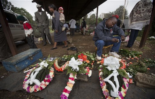 A street trader makes floral wreaths outside the mortuary in Nairobi, Kenya, on Wednesday. On Friday, Karen Wambui identified her son as the last person to be confirmed killed during the Sept. 21, al-Shabab terrorist assault on the Westgate Mall in Nairobi, Kenya.