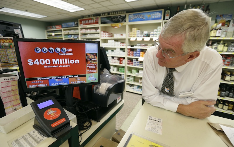 Dahl's grocery store manager Don Mark looks at a monitor displaying the estimated jackpot amount for Wednesday's Powerball drawing, Tuesday, Sept. 17, 2013, in Des Moines, Iowa. The giant Powerball jackpots keep coming, with the latest $400 million prize ranking among the largest ever. But soon, lottery players could see even more huge jackpots as organizers of the Mega Millions lottery move ahead with plans to revamp the game and attract more players. (AP Photo/Charlie Neibergall)