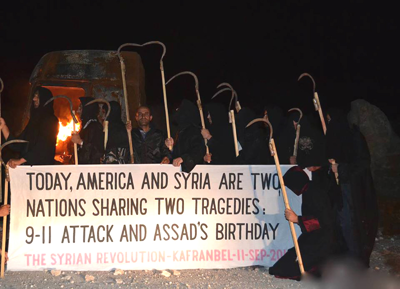 Citizen journalism image provided by Edlib News Network, which has been authenticated based on its contents and other AP reporting, show anti-Syrian regime protesters carrying a banner during a sit-in, at Kafr Nabil town, in Idlib province, northern Syria, on Wednesday.