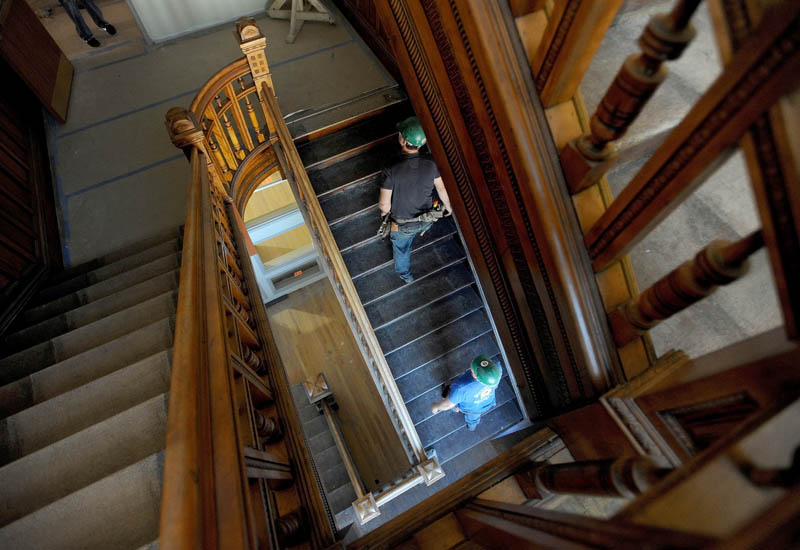 Construction workers with Sheridan Construction climb the grand staircase in the Gerald Hotel in downtown Fairfield on Sept. 18.