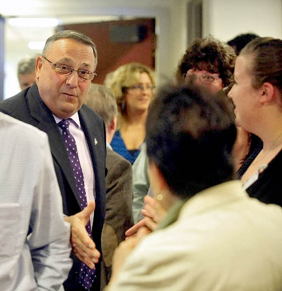 Gov. Paul LePage shakes hands with hospital employees during a press conference at Inland Hospital in Waterville on Wednesday. LePage made the appearance to announce repayment of state MaineCare debt to Maine's 39 hospitals, including $9.5 million to Inland Hospital.