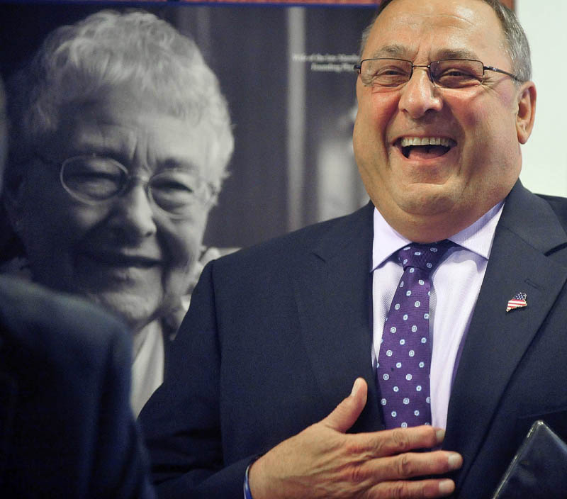 Gov. Paul LePage laughs as he is introduced by John Dalton, president and CEO of Inland Hospital, during a press conference at the hospital in Waterville on Wednesday. LePage made the appearance to announce repayment of state MaineCare debt to Maine's 39 hospitals, including $9.5 million to Inland Hospital.