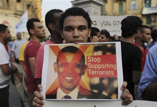 A demonstrator holds a placard with a picture of U.S. President Barack Obama during a protest against a possible strike against Syria, in Cairo, Egypt, on Sunday. Obama's decision to overrule his new foreign policy team's first decision to use of military force wound up being a stark lesson in the president's ability to overrule them all.