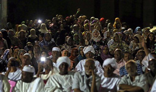 Sudanese anti-government protesters chant slogans during a demonstration in Khartoum, Sudan, on Sunday. Thousands of Sudanese protesters took to the streets in night march in the capital Khartoum late Sunday.