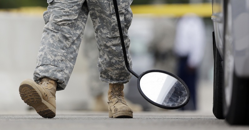 In this Aug. 27, 2013 file photo, a mirror is used on a vehicle at a security checkpoint to enter the Lawrence William Judicial Center as the sentencing phase for Maj. Nidal Hasan continues in Fort Hood, Texas. Hasan was convicted of killing 13 of his unarmed comrades in the deadliest attack ever on a U.S. military base. The rampage Monday, Sept. 16, 2013, at the Washington Naval Yard shocked the military, just as the attack at Fort Hood did. Defense Secretary is ordering a review of base security worldwide, and the issuing of security clearances that allow access to them, vowing: "Where there are gaps, we will close them." (AP Photo/Eric Gay, File)
