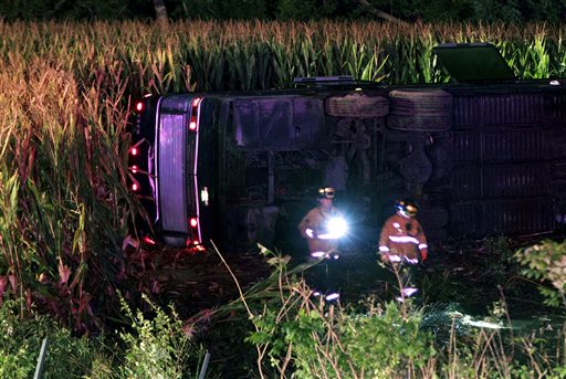 Officials work the scene of an overturned Greyhound bus on interstate I-75 in Liberty Township, Ohio, early Saturday. Authorities say that at least 34 people were hurt in the crash, with injuries ranging from minor to severe.