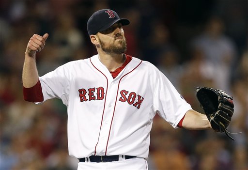 Boston Red Sox's John Lackey reacts after the final pop out by Baltimore Orioles' Adam Jones in the ninth inning of a baseball game in Boston, Thursday. Lackey pitched a complete game and the Red Sox won 3-1.