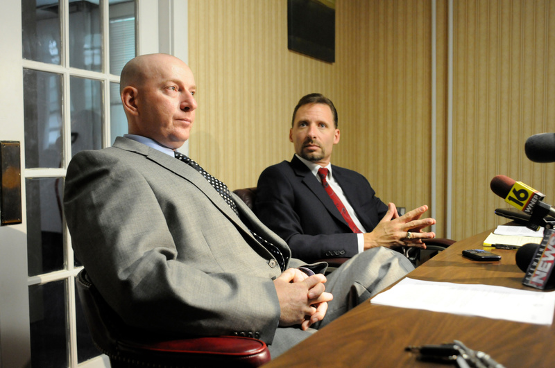Gilberton Police Chief Mark Kessler, foreground, and his attorney Joseph P. Nahas speak during a news conference in August.