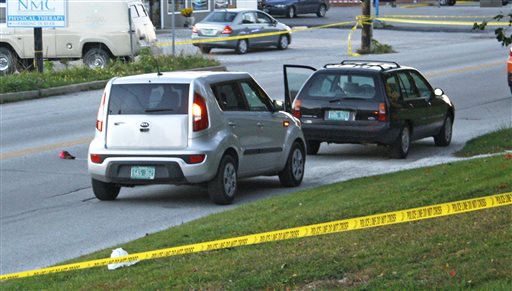Two vehicles involved in a roadside shooting on North Main Street in St. Albans, Vt., are surrounded by police tape on Wednesday.