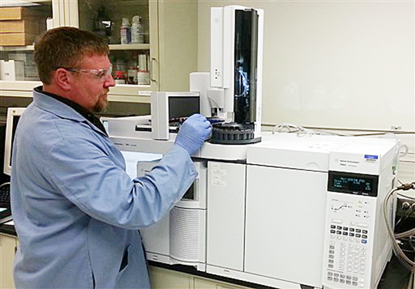 In this image provided by the Department of Energy, chemist Brian Dockendorff works on a mass spectrometer at the Pacific Northwest National Laboratory in Richland, Wash. Carlos Fraga, a chemist at the lab who specializes in nerve agent forensics, says the numbers 99-125-81 are sarin's fingerprint.