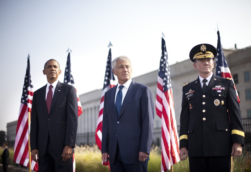 President Barack Obama, left, Secretary of Defense Chuck Hagel, center, and Joint Chiefs of Staff Chairman Gen. Martin Dempsey, right, on stage at the Pentagon in Washington, Wednesday, Sept. 11, 2013, to mark the 12th anniversary of the 9/11 attacks. (AP Photo/Pablo Martinez Monsivais)